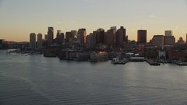 6k aerial stock footage flying by the downtown skyline, Downtown Boston, Massachusetts, sunset Aerial Stock Footage | AX146_078E