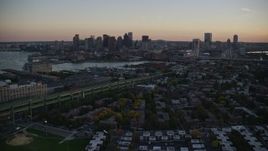 6k aerial stock footage flying by Downtown Boston skyline, from Charlestown, Massachusetts, sunset Aerial Stock Footage | AX146_102E