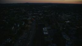 6k aerial stock footage flying over Columbus Avenue, train tracks, Jamaica Plain, Massachusetts, twilight Aerial Stock Footage | AX146_149E