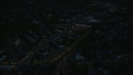 6k aerial stock footage flying over suburbs, approaching strip mall, Hyde Park, Massachusetts, night Aerial Stock Footage | AX146_157E