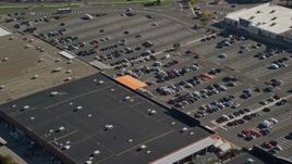6K aerial stock footage flying by a shopping mall and parking lot with cars, Dorchester, Massachusetts Aerial Stock Footage | AX147_005