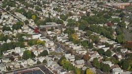 6K aerial stock footage flying away from suburban neighborhood and tree lined streets, Chelsea, Massachusetts Aerial Stock Footage | AX147_013