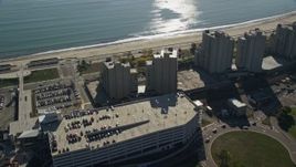 6K aerial stock footage flying over parking garage and beachfront condominiums, Revere, Massachusetts Aerial Stock Footage | AX147_014