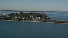 6K aerial stock footage approaching houses in a coastal community on a peninsula, Nahant, Massachusetts Aerial Stock Footage | AX147_016E