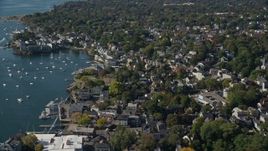 6K aerial stock footage flying over a coastal community with trees along the harbor, Marblehead, Massachusetts Aerial Stock Footage | AX147_026E