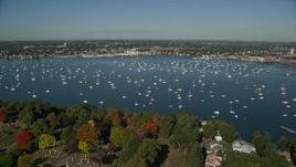 6K aerial stock footage flying over harbor with boats toward coastal community and warehouses, Salem, Massachusetts Aerial Stock Footage | AX147_033E