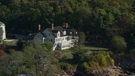 6K aerial stock footage approaching an oceanfront mansion among trees, autumn, Beverly, Massachusetts Aerial Stock Footage | AX147_055