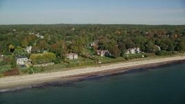 6K aerial stock footage flying by beachfront mansions and fall foliage, autumn, Beverly, Massachusetts Aerial Stock Footage | AX147_057E