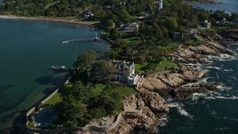 6K aerial stock footage orbiting an oceanfront mansion along Lobster Cove, Manchester-by-the-Sea, Massachusetts Aerial Stock Footage | AX147_062