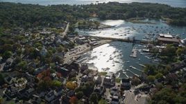 6K aerial stock footage flying away from a coastal community and harbor, autumn, Manchester-by-the-Sea, Massachusetts Aerial Stock Footage | AX147_069E