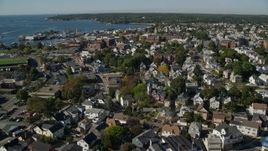 6K aerial stock footage flying over coastal town, colorful trees, Gloucester, Massachusetts Aerial Stock Footage | AX147_092E