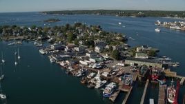 6K aerial stock footage flying by a small coastal town, piers, Gloucester, Massachusetts Aerial Stock Footage | AX147_094E