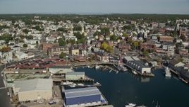 6K aerial stock footage approaching and flying over coastal town, warehouses, Gloucester, Massachusetts Aerial Stock Footage | AX147_099