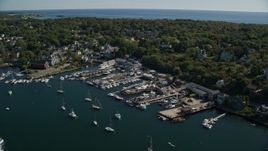 6K aerial stock footage flying over marina toward coastal town, Gloucester, Massachusetts Aerial Stock Footage | AX147_105