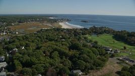 6K aerial stock footage flying over trees and coastal community toward beaches, Gloucester, Massachusetts Aerial Stock Footage | AX147_106