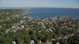 6K aerial stock footage flying along small coastal town with church in the distance, Rockport, Massachusetts Aerial Stock Footage | AX147_123E