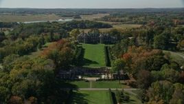 6K aerial stock footage flying over water Castle Hill and The Great House at Crane Estate in autumn, Ipswich, Massachusetts Aerial Stock Footage | AX147_138E