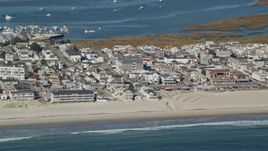6K aerial stock footage flying by a coastal town and beach, Hampton, New Hampshire Aerial Stock Footage | AX147_154E