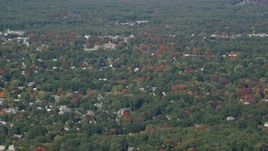 6K aerial stock footage flying over houses among colorful autumn trees, Hampton, New Hampshire Aerial Stock Footage | AX147_157