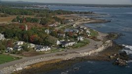6K aerial stock footage flying over ocean toward beachfront homes in autumn, Rye, New Hampshire Aerial Stock Footage | AX147_167E