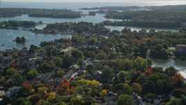 6K aerial stock footage flying over colorful autumn trees in a coastal town, Portsmouth, New Hampshire Aerial Stock Footage | AX147_184