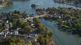 6K aerial stock footage of a small bridge and waterfront homes in autumn, Portsmouth, New Hampshire Aerial Stock Footage | AX147_185