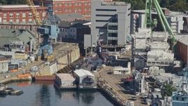 6k aerial stock footage flying by a submarine in a naval shipyard, Kittery, Maine Aerial Stock Footage | AX147_188