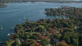 6K aerial stock footage of a small bridge approaching coastal homes in autumn, New Castle, New Hampshire Aerial Stock Footage | AX147_189E