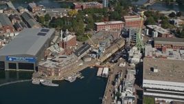 6k aerial stock footage flying by Portsmouth Naval Shipyard, submarine, Kittery, Maine Aerial Stock Footage | AX147_202