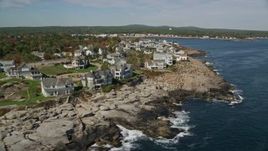 6K aerial stock footage flying by oceanfront mansions, rocky coast, autumn, York, Maine Aerial Stock Footage | AX147_243E
