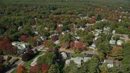 6K aerial stock footage flying by residential neighborhood, pan right, reveal coast, autumn, Ogunquit, Maine Aerial Stock Footage | AX147_252