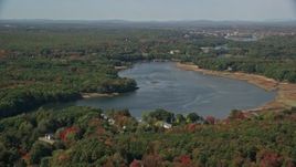 6K aerial stock footage flying by the Saco River, colorful trees in autumn, Saco, Maine Aerial Stock Footage | AX147_276