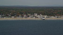 6K aerial stock footage flying by beach, pier and Palace Playland, autumn, Old Orchard Beach, Maine Aerial Stock Footage | AX147_296E