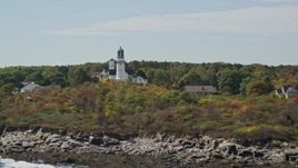 6K aerial stock footage flying away from coastal town, Cape Elizabeth Light, autumn, Cape Elizabeth, Maine Aerial Stock Footage | AX147_306