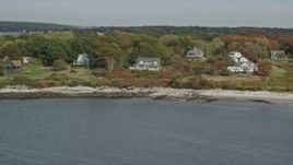 6K aerial stock footage flying by oceanfront homes, Cushing Island, autumn, Portland, Maine Aerial Stock Footage | AX147_317