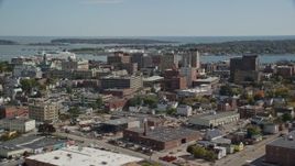 6K aerial stock footage flying by downtown office buildings, colorful autumn trees, Portland, Maine Aerial Stock Footage | AX147_357E