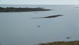 6k aerial stock footage flying over Haskell Island, approach lighthouse, Little Mark Island, Harpswell, Maine Aerial Stock Footage | AX147_375