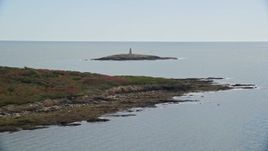 6K aerial stock footage flying over Haskell Island, approach lighthouse, Little Mark Island, Harpswell, Maine Aerial Stock Footage | AX147_375E
