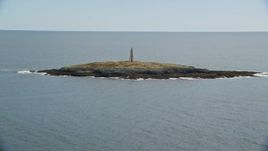 6k aerial stock footage flying by a lighthouse on Little Mark Island, Atlantic Ocean, Harpswell, Maine Aerial Stock Footage | AX147_377