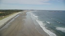 6K aerial stock footage flying by waves rolling onto the beach, autumn, Phippsburg, Maine Aerial Stock Footage | AX147_385