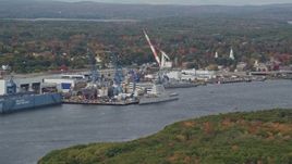 6K aerial stock footage flying by waterfront General Dynamics Bath Iron Works, autumn, Bath, Maine Aerial Stock Footage | AX147_410