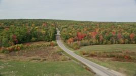 6K aerial stock footage flying by Old Ferry Road, approaching colorful forest, autumn, Wiscasset, Maine Aerial Stock Footage | AX147_422