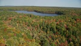 6k aerial stock footage flying over a colorful forest, approach Mccurdy Pond, autumn, Damariscotta, Maine Aerial Stock Footage | AX148_024