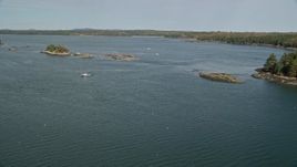 6K aerial stock footage flying by tiny islands, fishing boats, The Narrows. autumn, Waldoboro, Maine Aerial Stock Footage | AX148_031