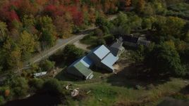 6k aerial stock footage flying over colorful forest, approach rural home, small ponds, autumn, Cushing, Maine Aerial Stock Footage | AX148_038