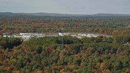 6k aerial stock footage flying by Maine State Prison, colorful forest, autumn, Warren, Maine Aerial Stock Footage | AX148_061