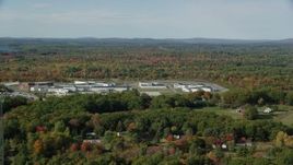 6k aerial stock footage orbiting Maine State Prison, colorful forest, autumn, Warren, Maine Aerial Stock Footage | AX148_062