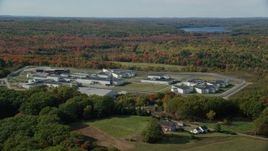 6k aerial stock footage orbiting Maine State Prison, colorful forest, autumn, Warren, Maine Aerial Stock Footage | AX148_063