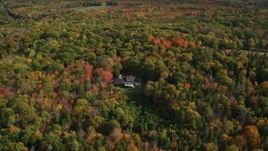 6K aerial stock footage flying by a lone rural home, colorful forest, autumn, Owls Head, Maine Aerial Stock Footage | AX148_079