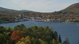 6K aerial stock footage approaching Curtis Island Light, reveal small coastal town, autumn, Camden, Maine Aerial Stock Footage | AX148_109E